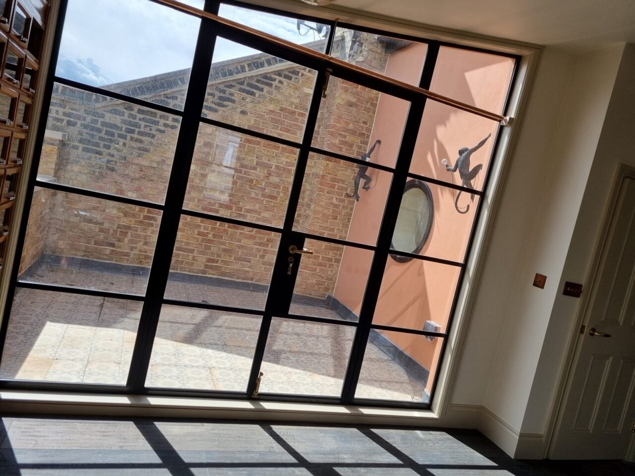 Internal Crittall screen onto a courtyard in a Woodford loft conversion by Brick By Brick