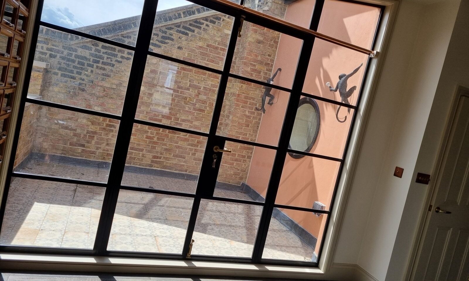 Internal Crittall screen onto a courtyard in a Woodford loft conversion by Brick By Brick